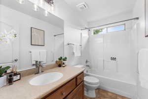 Bathroom with vanity, shower / bathtub combination, and tile patterned flooring