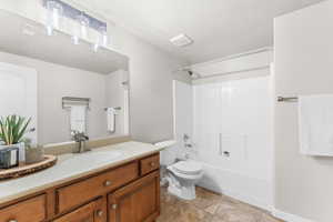 Full bath with vanity, tub / shower combination, and tile patterned flooring