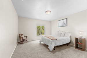 Carpeted bedroom with baseboards