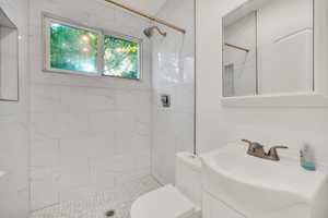 Bathroom featuring vanity and a tile shower