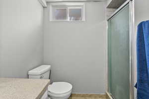 Full bathroom featuring a shower stall, vanity, and tile patterned floors