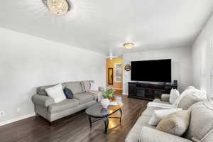 Living area with dark wood finished floors and a textured ceiling