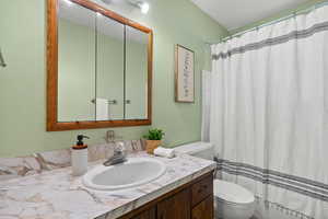 Full bathroom with vanity and toilet