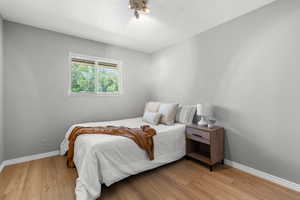 Bedroom with light wood-style floors and baseboards