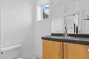 Half bath featuring toilet and vanity