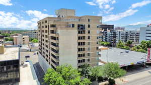 View of apartment building / complex with a mountain view and a view of city