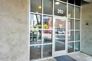 Doorway to property featuring stucco siding