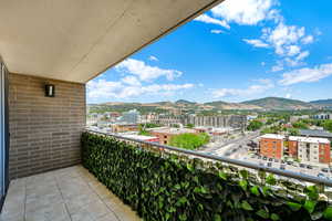 Balcony featuring a view of city and a mountain view