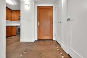 Hallway featuring baseboards and inlaid floor details