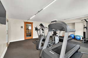 Workout area featuring baseboards