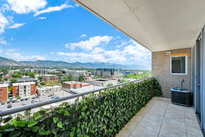 Balcony with a mountain view and a view of city