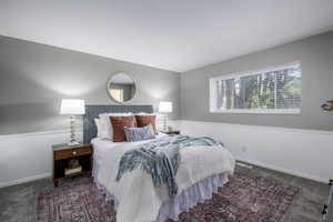 Bedroom featuring carpet floors and baseboards
