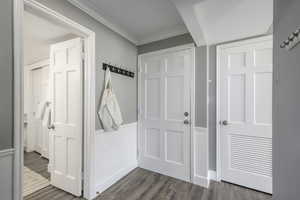 Foyer featuring dark wood finished floors and ornamental molding