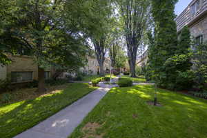 View of property's community featuring a lawn and a residential view