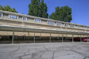 View of front of property with brick siding and covered parking