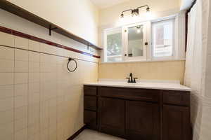 Upstairs Full bathroom with original tile walls, floors and brand-new vanity