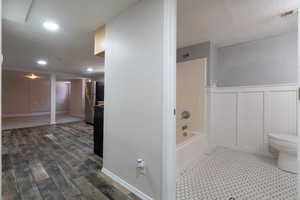 Full bathroom in the basement featuring wainscoting, hexagon tile floors and new vanity.