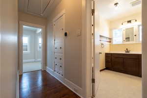 Hall featuring attic access, Linen closet with original hardware.