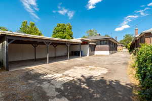 view from back southwest corner. 4 carport spots and a shed.