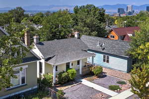 View of front of house with a mountain view, a shingled roof, and a chimney