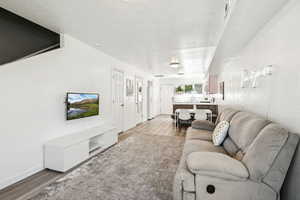 Living area with light wood-style floors and baseboards