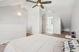 Bedroom featuring carpet floors, a ceiling fan, and ensuite bath