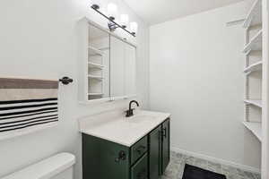 Bathroom featuring vanity and toilet