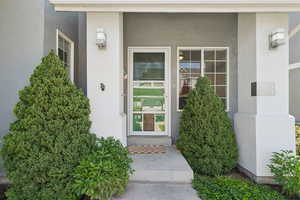 View of exterior entry featuring stucco siding