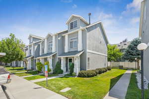 Townhome / multi-family property with a residential view and stucco siding