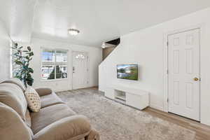 Living room featuring light wood-style flooring and baseboards