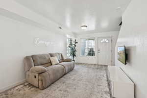 Living room featuring baseboards and light wood-style flooring