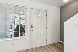 Entryway featuring wood finished floors and baseboards