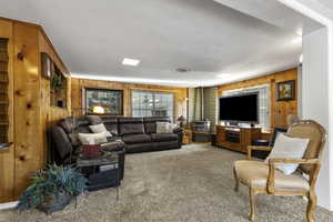 Gathering Room with Classic Knotty Pine and Gas Stove.