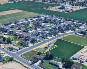 Aerial view of property and surrounding area featuring nearby suburban area