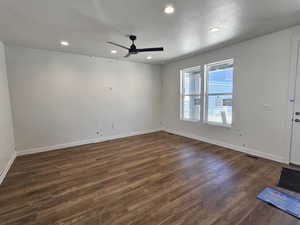 Unfurnished room with dark wood-style flooring, a ceiling fan, recessed lighting, and a textured ceiling