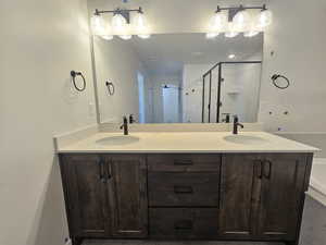 Bathroom with double vanity and a shower stall