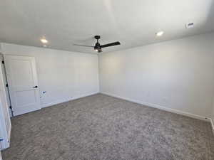 Spare room with carpet flooring, ceiling fan, a textured ceiling, and recessed lighting