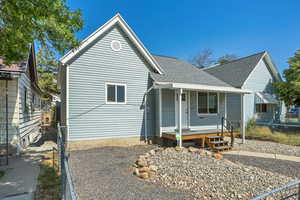 View of front of home with covered porch and roof with shingles