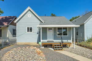 View of front of property featuring a porch and a shingled roof