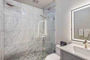 Bathroom with a tile shower and vanity