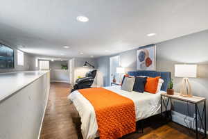 Bedroom with wood finished floors and recessed lighting
