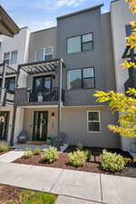 Multi unit property with a balcony, stucco siding, and french doors