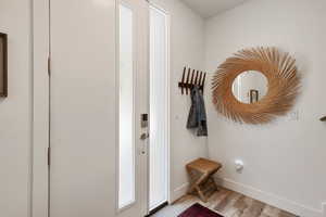 Entryway with light wood-style flooring and baseboards