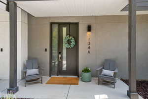 Property entrance featuring stucco siding