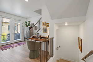 Entryway featuring wood finished floors, recessed lighting, and stairway