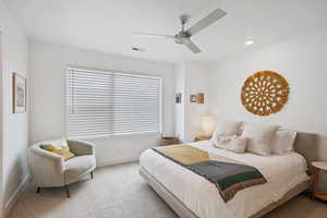 Carpeted bedroom featuring ceiling fan and recessed lighting
