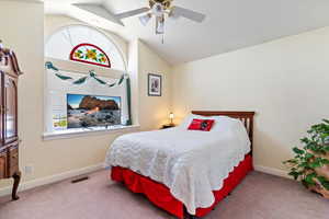 Bedroom featuring lofted ceiling, carpet flooring, and ceiling fan