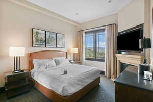 Carpeted bedroom featuring a fireplace