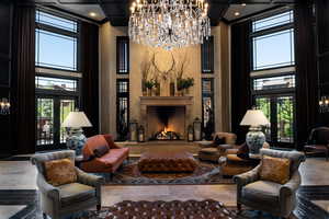 Living area featuring a chandelier and a towering ceiling