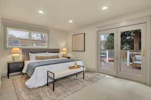 Bedroom featuring access to exterior, light colored carpet, and recessed lighting